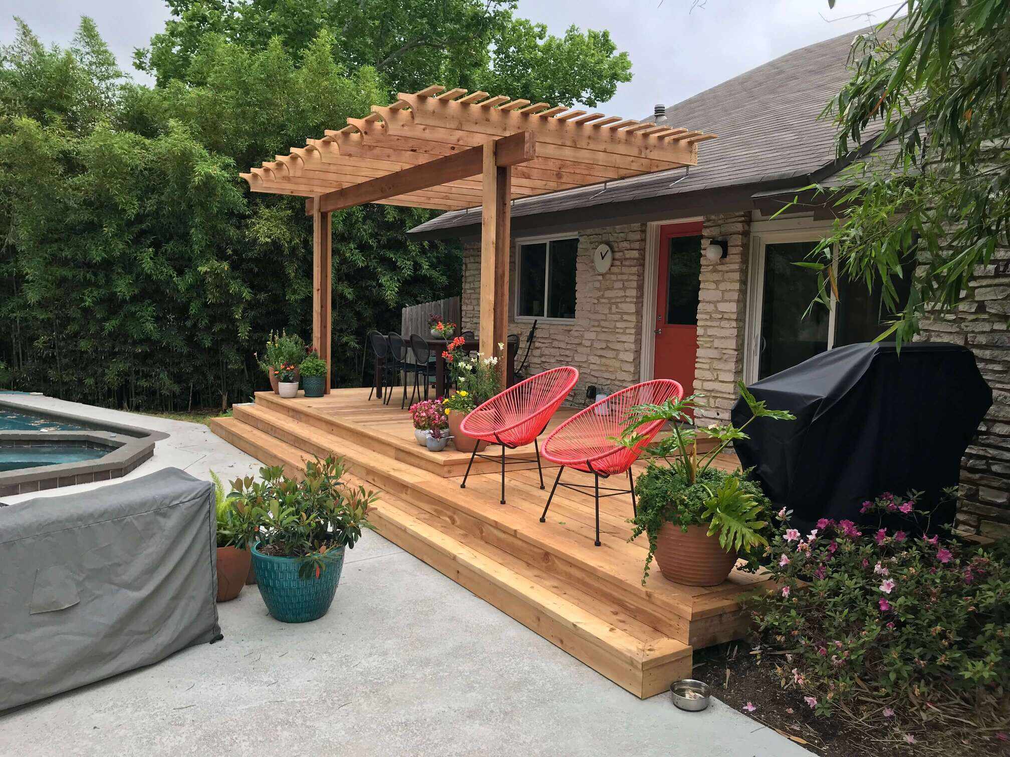 Custom pergola, deck and poolside outdoor living space by Oasis Outdoor Solutions