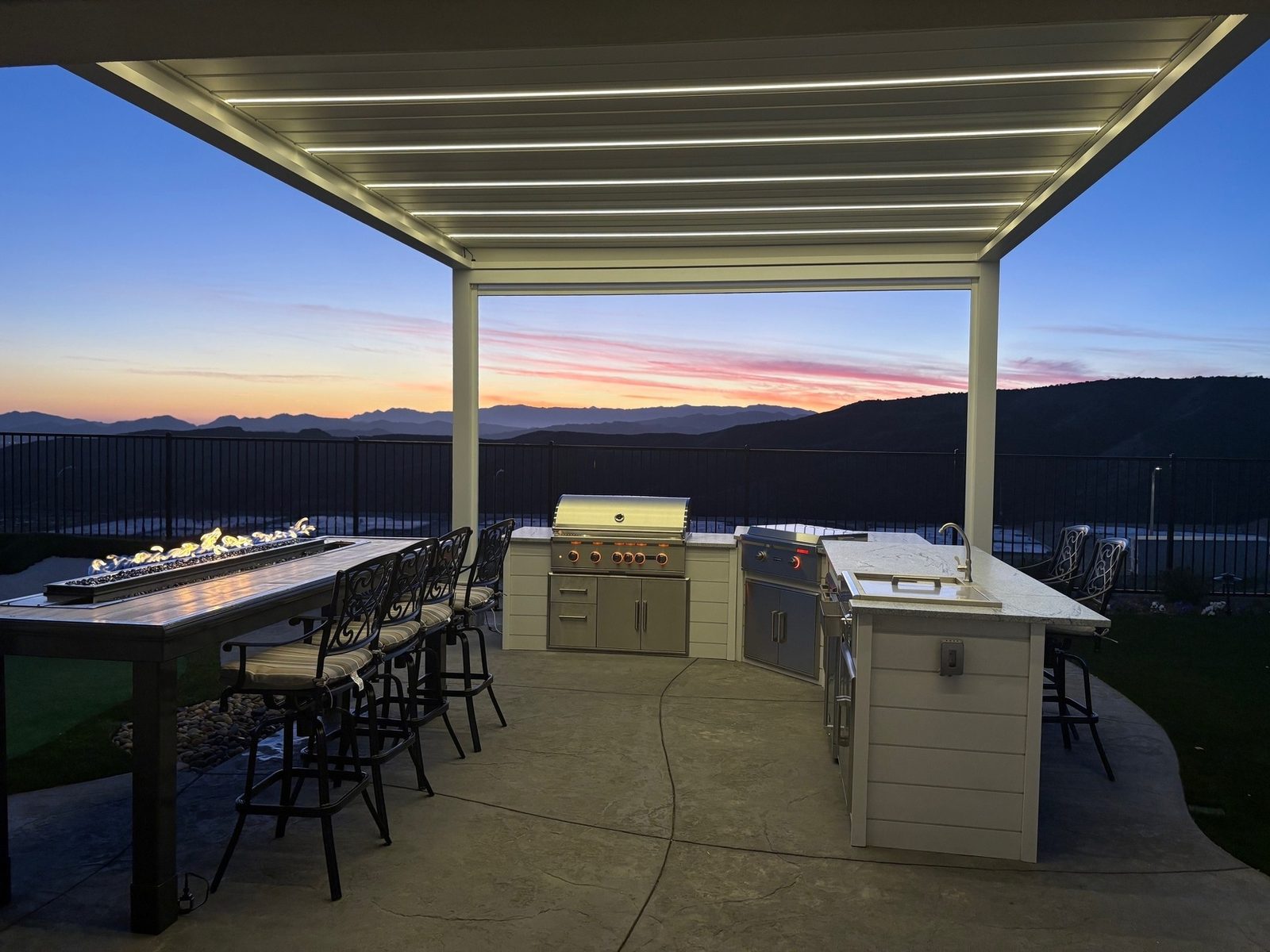 Outdoor kitchen connected to patio seating